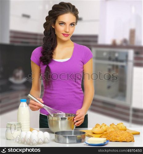 Young cooking woman at kitchen