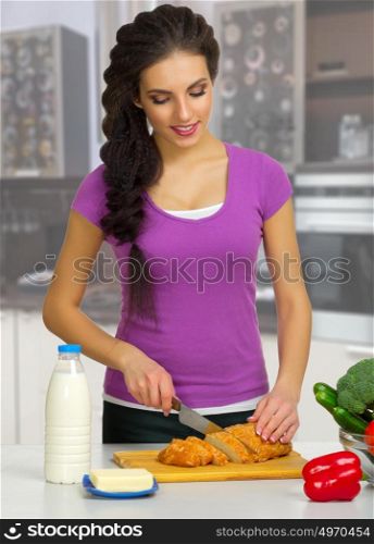 Young cooking woman at kitchen