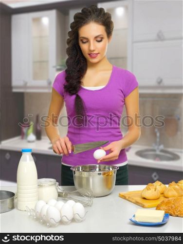 Young cooking woman in the kitchen