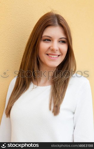 Young cool woman with a yellow wall of background