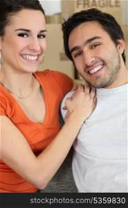 young couple all smiles moving flats