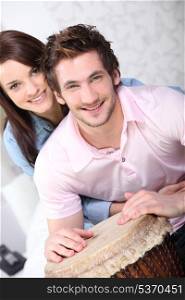young couple all smiles with djembe drum