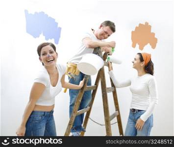 Young couple and friend improving their home.