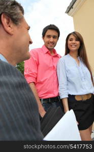 Young couple and realtor