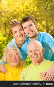 Young couple and their grandparents outdoors