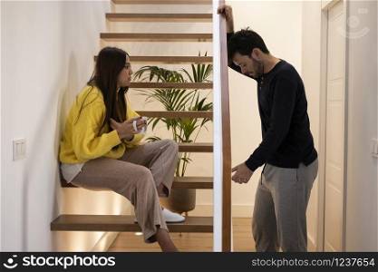 young couple arguing inside the house. concept of psychological abuse