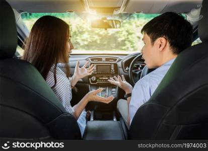 young couple arguing while driving a car
