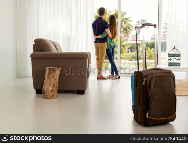 Young couple arriving the hotel for holidays