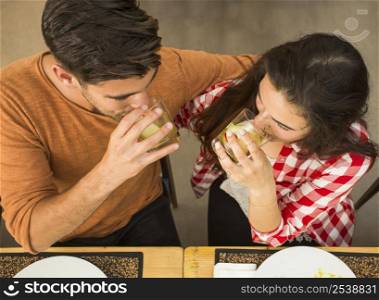 Young couple at a restaurant drinking and having a good time