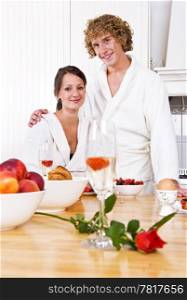 Young couple at a valentine&rsquo;s breakfast at the counter in a cosy kitchen