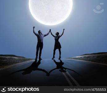 Young couple at date. Silhouettes of young couple against full moon