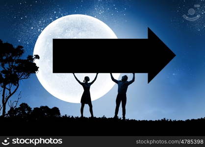 Young couple at date. Silhouettes of young couple against full moon