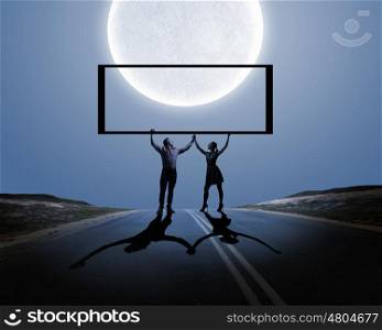 Young couple at date. Silhouettes of young couple against full moon