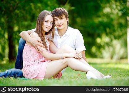 Young couple at green grass.