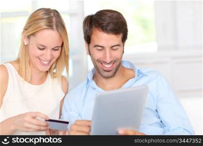 Young couple at home doing online shopping