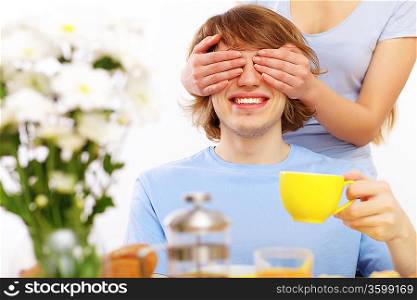 Young couple at home together - closing partner&acute;s eyes