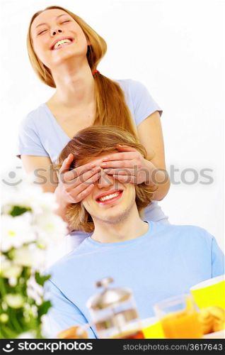 Young couple at home together - closing partner&acute;s eyes