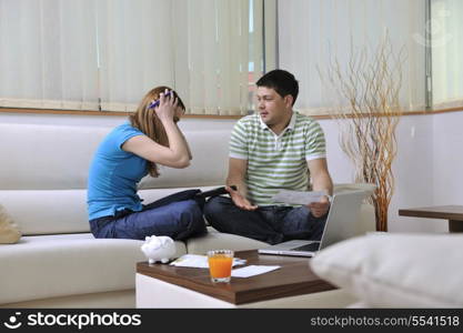 young couple at home with modern livingroom indoor working on laptop on house finance and planing