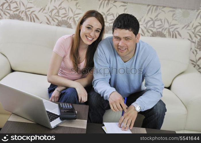 young couple at home with modern livingroom indoor working on laptop on house finance and planing