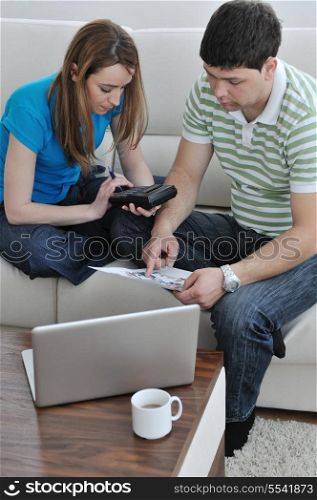young couple at home with modern livingroom indoor working on laptop on house finance and planing