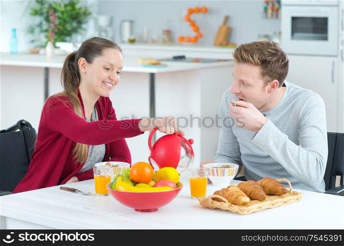 young couple at the kitchen having fun