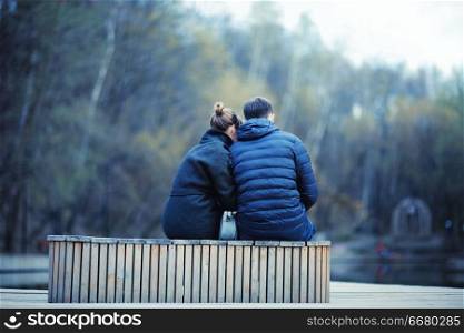young couple at the park in winter view from the back