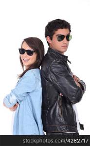 Young couple being cool in sunglasses and leather jacket