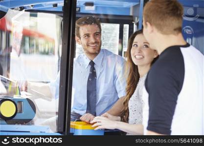 Young Couple Boarding Bus And Buying Ticket