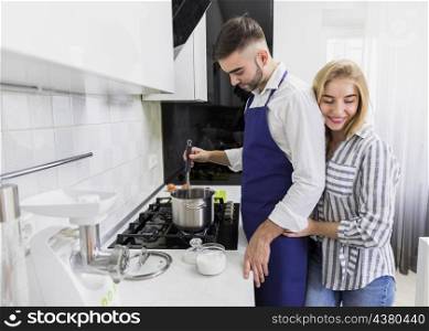 young couple boiling water pot