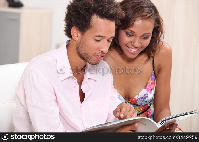 Young couple browsing through magazine