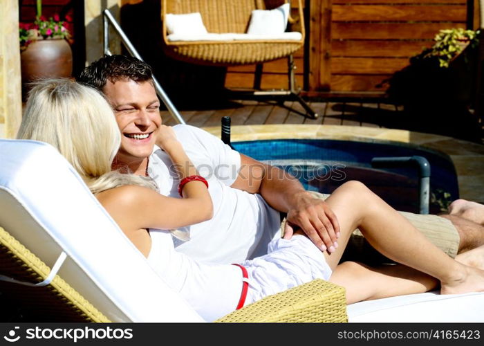 Young couple by pool at resort
