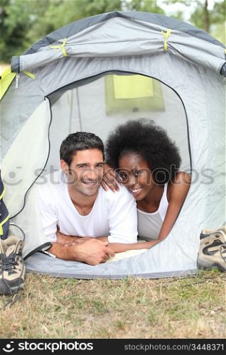 Young couple camping in tent