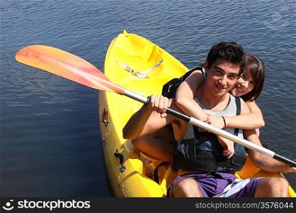 young couple canoeing in lake