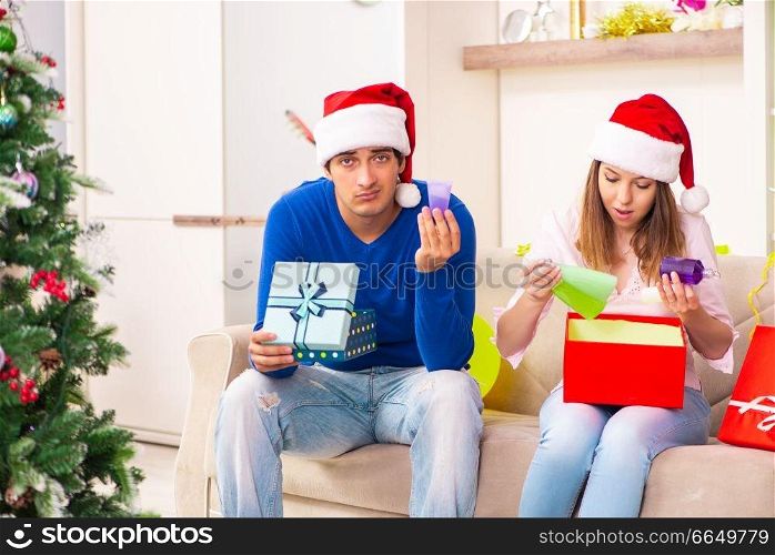 Young couple celebrating christmas at home