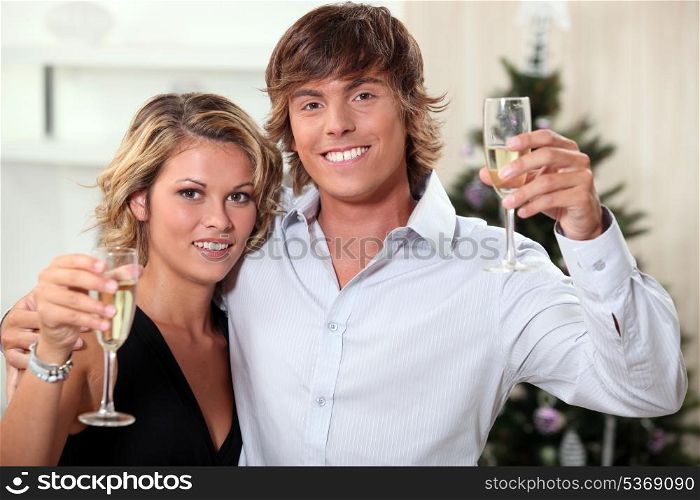 Young couple celebrating Christmas with champagne