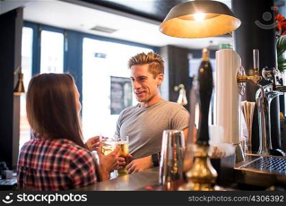 Young couple chatting at city bar