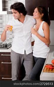 Young couple chatting while thier drink in the kitchen