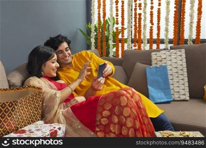 Young couple checking a photo togther and laughing
