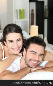 Young couple cheerful laid in bed