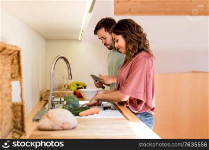 Young couple chilling out while preparing the lunch