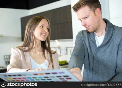 young couple choosing a colour for their walls