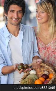 Young couple choosing fruit