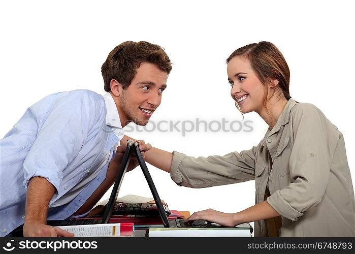 Young couple competing with laptops
