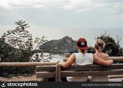 Young couple contemplating Gaztelugatxe Island in Vizcaya, Spain