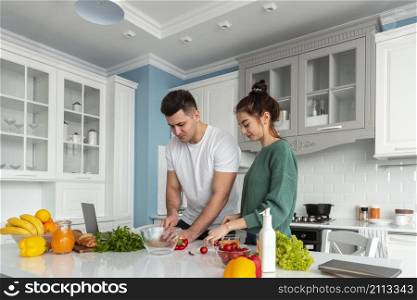 young couple cooking home
