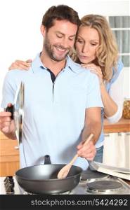 Young couple cooking in kitchen
