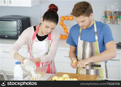young couple cooking together at home