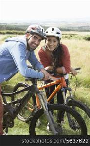 Young Couple Cycling In Countryside