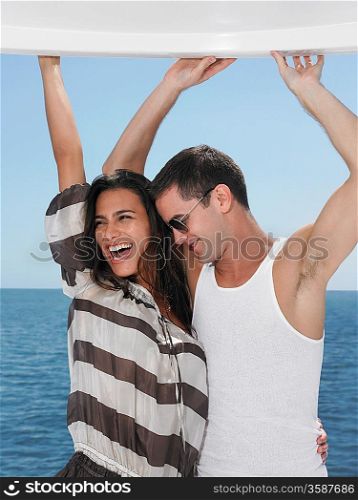 Young couple dancing sea in background