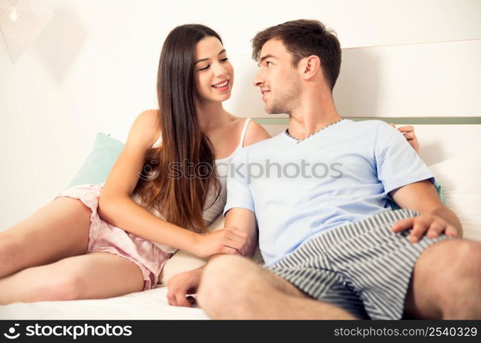 Young couple dating on a hotel bedroom